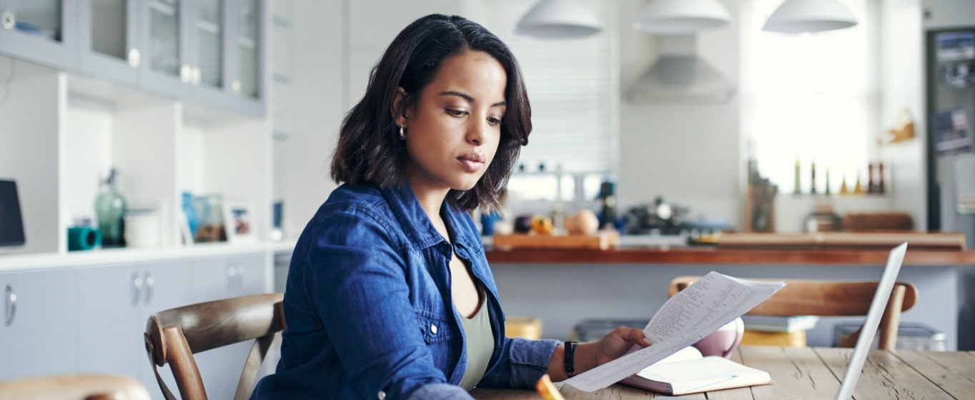 a young woman doing her finances at home