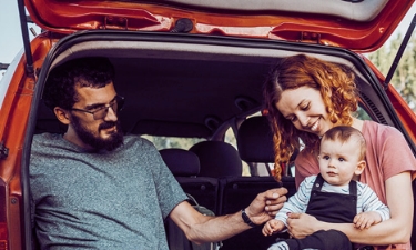 father, mother and son sitting in the car